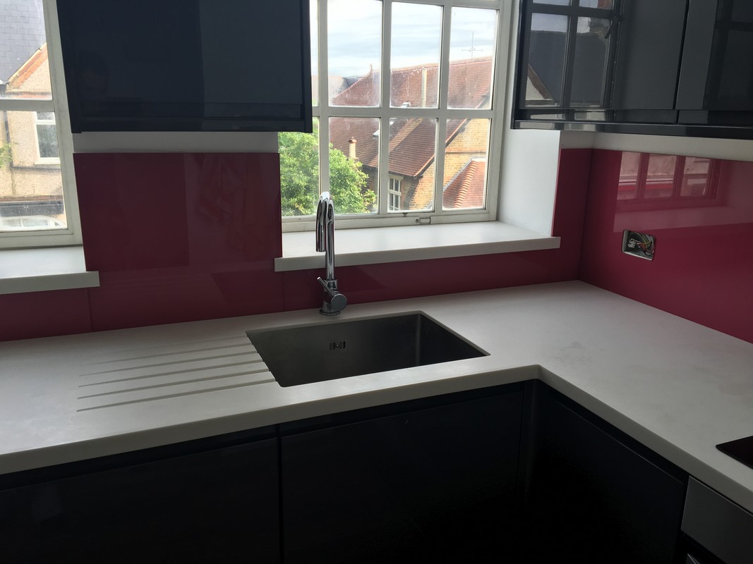 Deep plum coloured glass splashback in modern Olympic Park kitchen